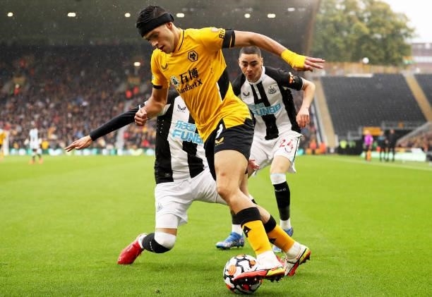 Raul Jimenez of Wolverhampton Wanderers is challenged by Javier Manquillo of Newcastle United during the Premier League match between Wolverhampton...