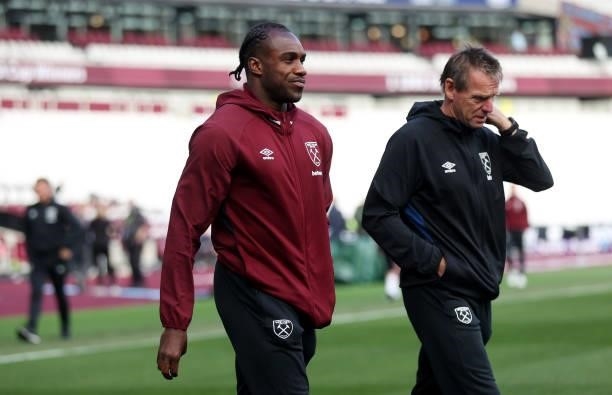 Michail Antonio of West Ham United speaks with Stuart Pearce as they arrive at the stadium prior to the Premier League match between West Ham United...
