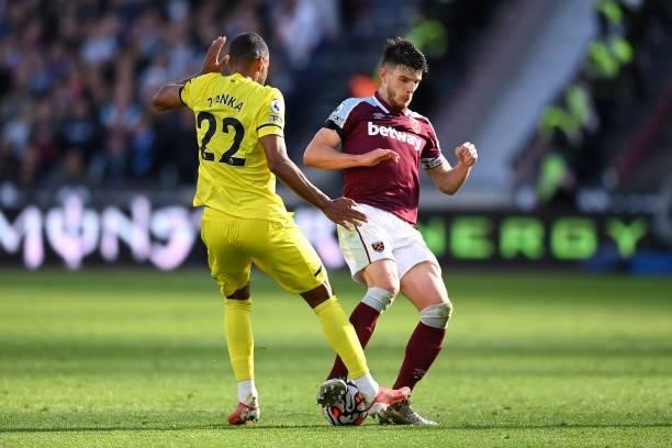 Declan Rice of West Ham United battles for possession with Mathias Zanka Joergensen of Brentford during the Premier League match between West Ham...
