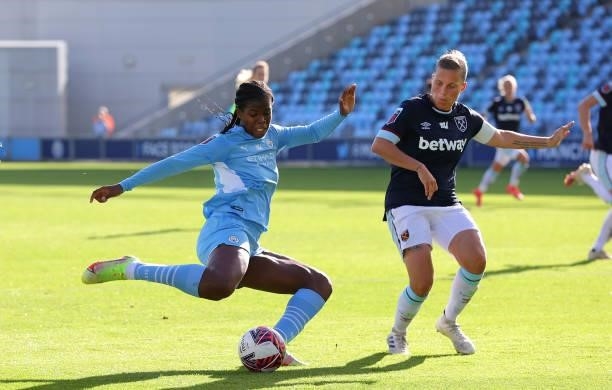 Khadija Shaw of Manchester City Women shoots ahead of Gilly Flaherty of West Ham United Women during the Barclays FA Women's Super League match...