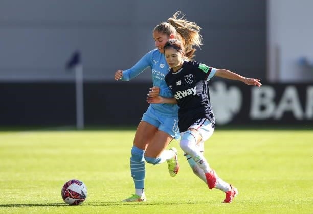 Janine Beckie of Manchester City Women is tackled by Yui Hasegawa of West Ham United Women during the Barclays FA Women's Super League match between...