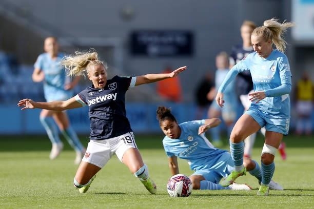 Adriana Leon of West Ham United is challenged by Demi Stokes and Alex Greenwood of Manchester City during the Barclays FA Women's Super League match...