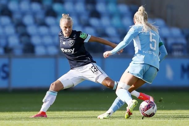Tameka Yallop of West Ham United is challenged by Alex Greenwood of Manchester City during the Barclays FA Women's Super League match between...