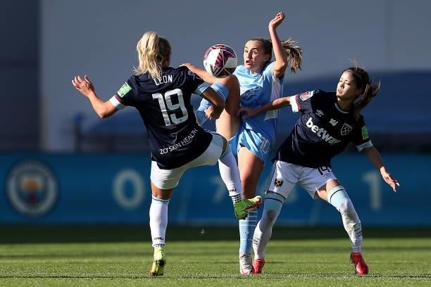 Georgia Stanway of Manchester City is challenged by Adriana Leon and Yui Hasegawa of West Ham United during the Barclays FA Women's Super League...