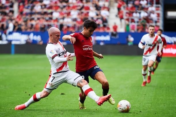 Manu Sanchez of CA Osasuna duels for the ball with Isi Palazon of Rayo Vallecano during the La Liga Santander match between CA Osasuna and Rayo...