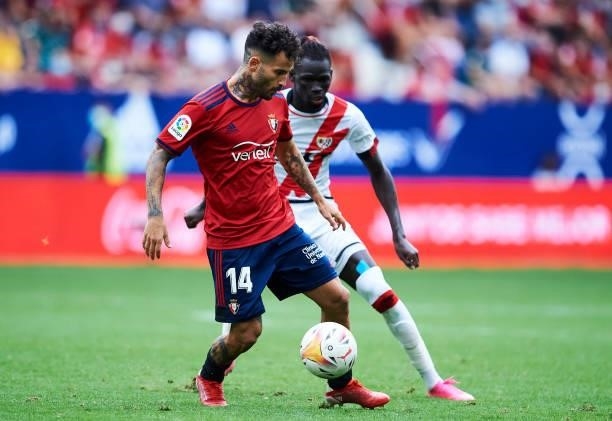 Ruben Garcia of CA Osasuna duels for the ball with Pathe Ciss of Rayo Vallecano during the La Liga Santander match between CA Osasuna and Rayo...
