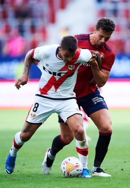 Lucas Torro of CA Osasuna duels for the ball with Oscar Trejo of Rayo Vallecano during the La Liga Santander match between CA Osasuna and Rayo...