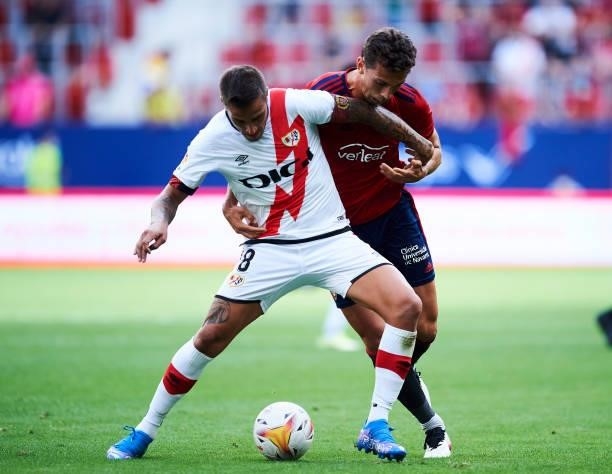 Lucas Torro of CA Osasuna duels for the ball with Oscar Trejo of Rayo Vallecano during the La Liga Santander match between CA Osasuna and Rayo...