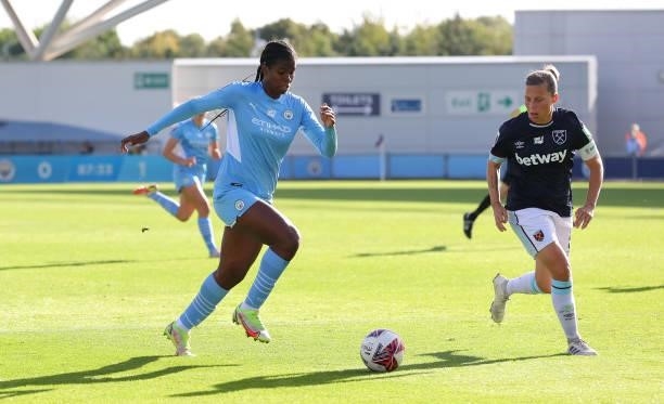Khadija Shaw of Manchester City Women runs at Gilly Flaherty of West Ham United Women during the Barclays FA Women's Super League match between...
