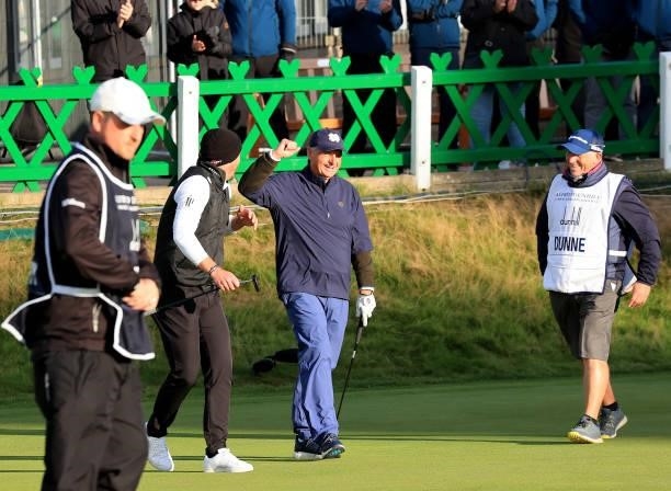 Danny Willett of England congratulates his amateur playing partner Jimmy Dunne on the 18th green during the final round of The Alfred Dunhill Links...