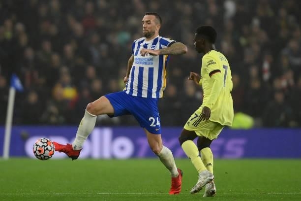 Shane Duffy of Brighton & Hove Albion is challenged by Bukayo Saka of Arsenal during the Premier League match between Brighton & Hove Albion and...