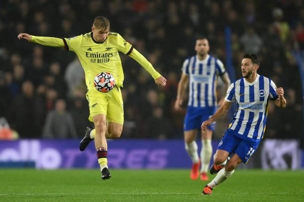 Emile Smith Rowe of Arsenal is challenged by Adam Lallana of Brighton & Hove Albion during the Premier League match between Brighton & Hove Albion...