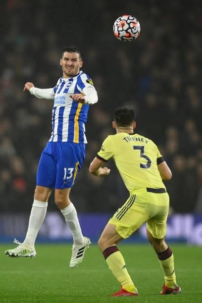 Pascal Gross of Brighton & Hove Albion is challenged by Kieran Tierney of Arsenal during the Premier League match between Brighton & Hove Albion and...