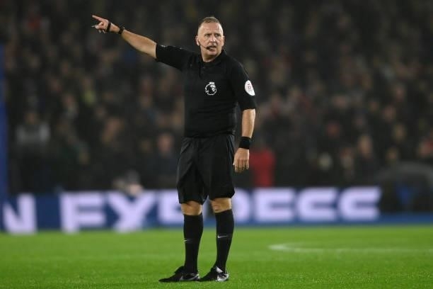 Referee Jonathan Moss signals during the Premier League match between Brighton & Hove Albion and Arsenal at American Express Community Stadium on...