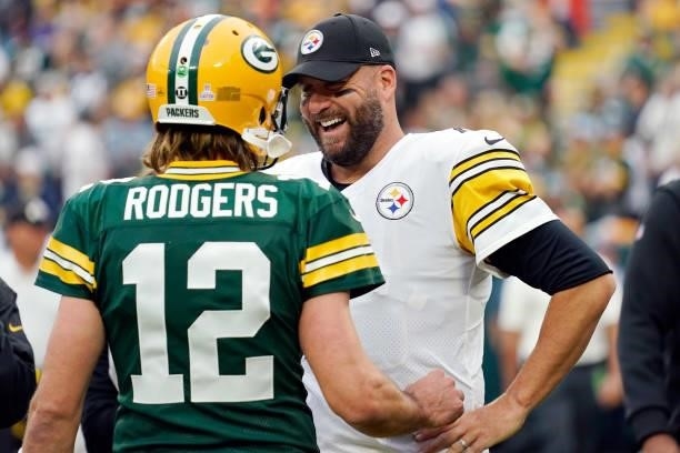 Aaron Rodgers of the Green Bay Packers talks with Ben Roethlisberger of the Pittsburgh Steelers before the game at Lambeau Field on October 03, 2021...