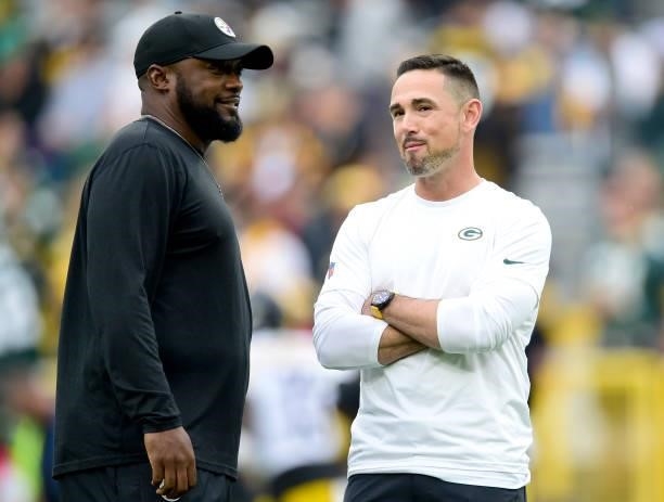 Head coach Mike Tomlin of the Pittsburgh Steelers talks with head coach Matt LaFleur of the Green Bay Packers before the game at Lambeau Field on...