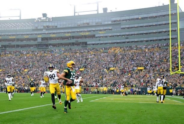 Aaron Rodgers of the Green Bay Packers runs for a touchdown during the second quarter against the Pittsburgh Steelers at Lambeau Field on October 03,...