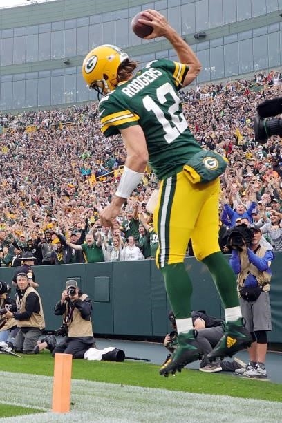 Aaron Rodgers of the Green Bay Packers celebrates after running for a touchdown during the second quarter against the Pittsburgh Steelers at Lambeau...