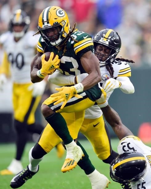 Aaron Jones of the Green Bay Packers is tackled by Terrell Edmunds of the Pittsburgh Steelers during the second quarter at Lambeau Field on October...