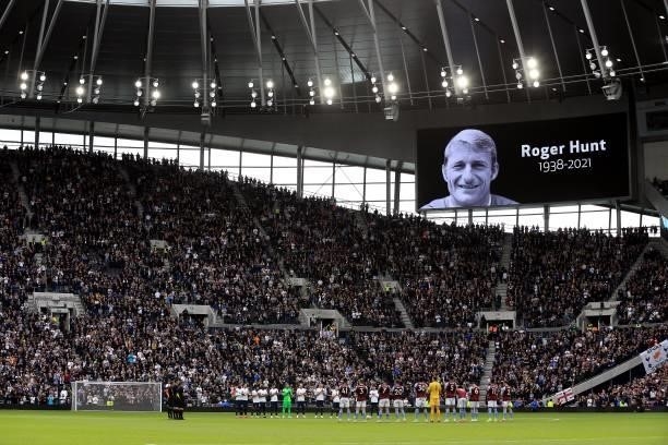 The LED screen displays an image of Roger Hunt as players of both teams stand for a minute of applause in memory of former footballer, Roger Hunt who...