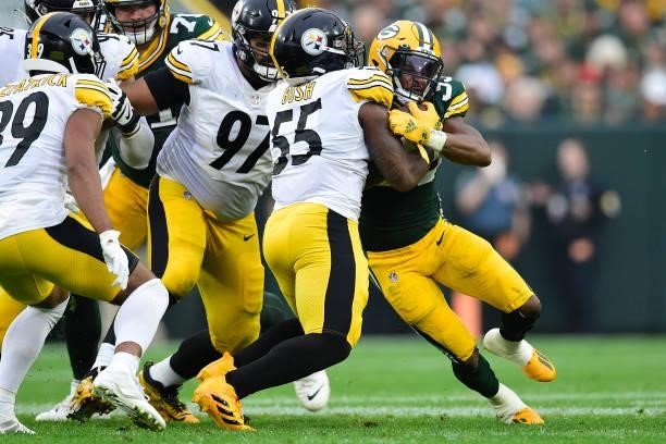 Aaron Jones of the Green Bay Packers is tackled by Devin Bush of the Pittsburgh Steelers during the second quarter at Lambeau Field on October 03,...