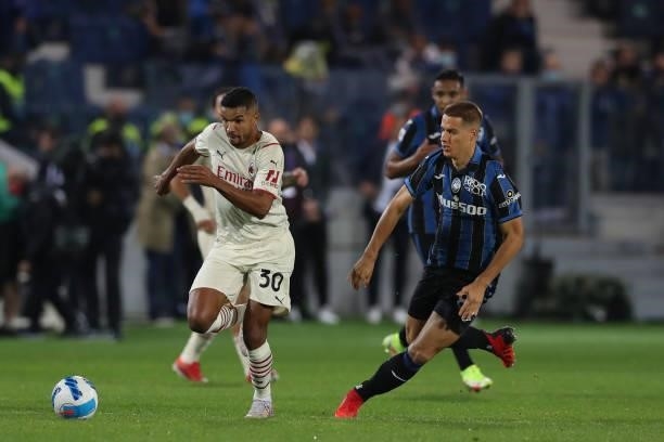 Junior Messias of AC Milan is pursued by Mario Pasalic of Atalanta during the Serie A match between Atalanta BC v AC Milan at Gewiss Stadium on...