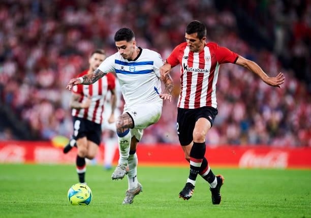 Miguel De la Fuente of Deportivo Alaves duels for the ball with Daniel Vivian of Athletic Club during the Laliga Santander match between Athletic...