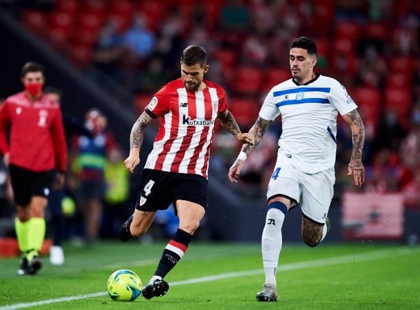 Miguel De la Fuente of Deportivo Alaves duels for the ball with Inigo Martinez of Athletic Club during the Laliga Santander match between Athletic...