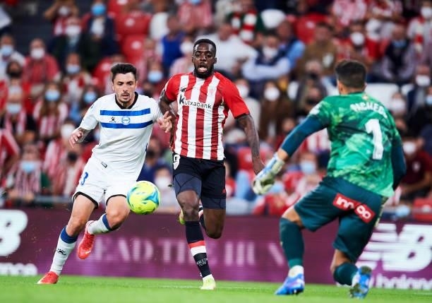 Ximo Navarro of Deportivo Alaves duels for the ball with Inaki Williams of Athletic Club during the Laliga Santander match between Athletic Club and...