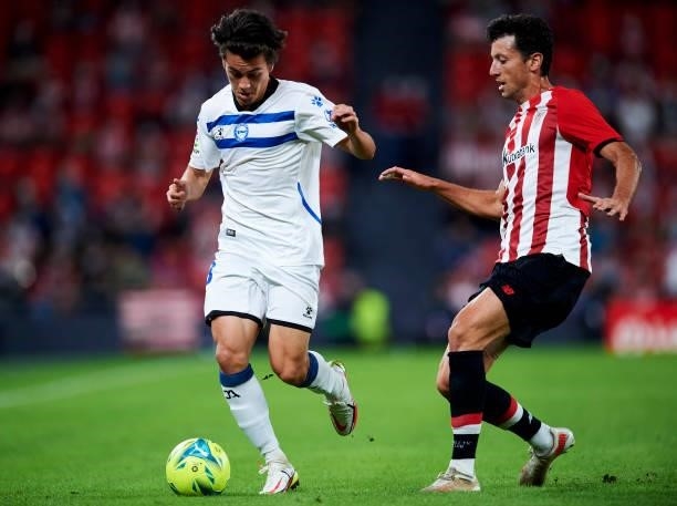 Facundo Pellistri of Deportivo Alaves duels for the ball with Inigo Lekue of Athletic Club during the Laliga Santander match between Athletic Club...