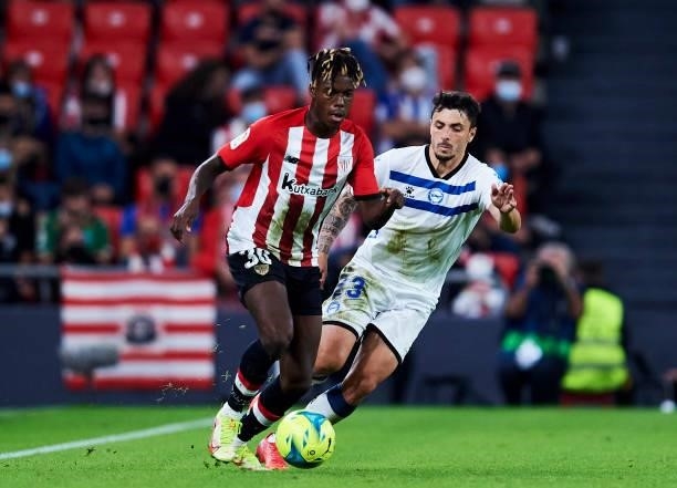 Ximo Navarro of Deportivo Alaves duels for the ball with Nico Williams Jr of Athletic Club during the Laliga Santander match between Athletic Club...
