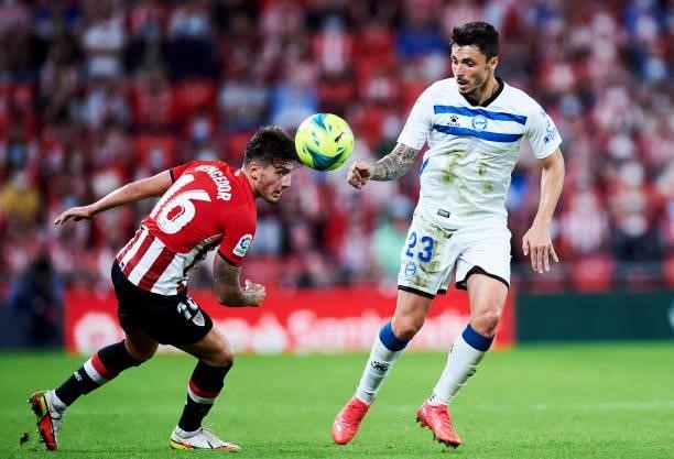 Ximo Navarro of Deportivo Alaves duels for the ball with Unai Vencedor of Athletic Club during the Laliga Santander match between Athletic Club and...