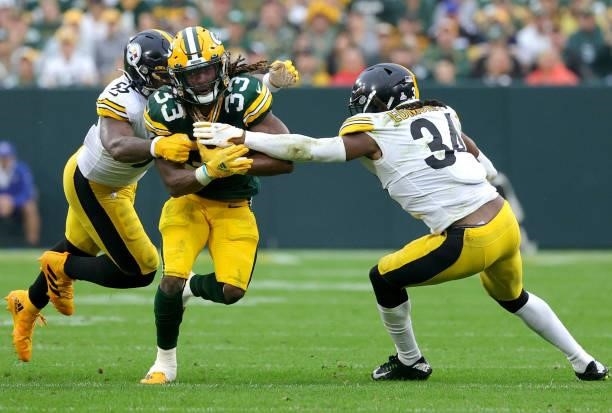 Aaron Jones of the Green Bay Packers is tackled by Devin Bush and Terrell Edmunds of the Pittsburgh Steelers during the third quarter at Lambeau...
