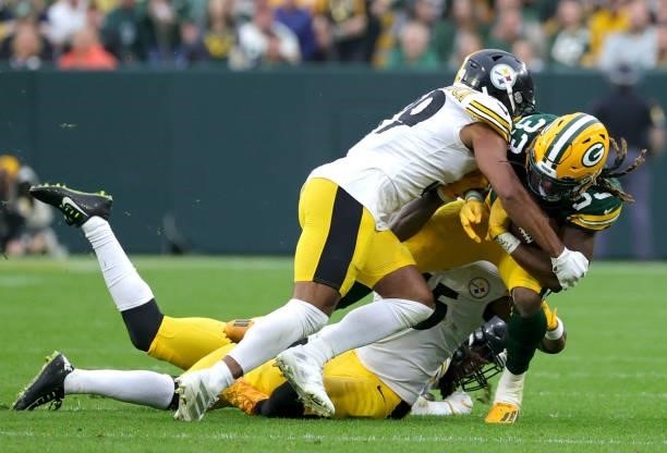 Aaron Jones of the Green Bay Packers is tackled by Devin Bush and Minkah Fitzpatrick of the Pittsburgh Steelers of the Pittsburgh Steelers during the...
