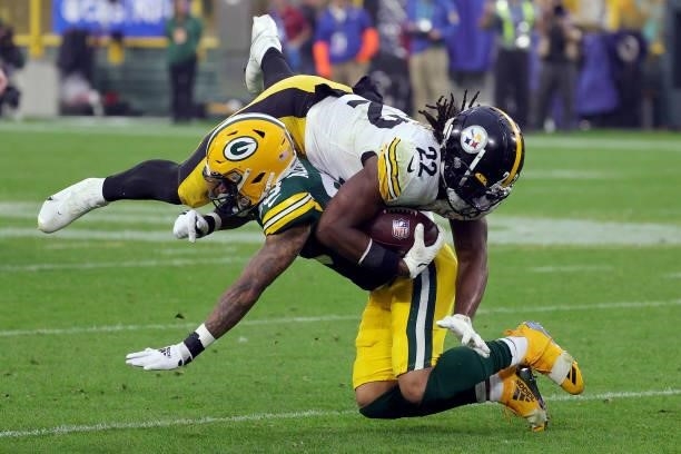 Najee Harris of the Pittsburgh Steelers is tackled by Jaire Alexander of the Green Bay Packers during the third quarter at Lambeau Field on October...