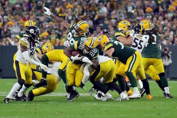 Dillon of the Green Bay Packers runs the ball during the fourth quarter against the Pittsburgh Steelers at Lambeau Field on October 03, 2021 in Green...