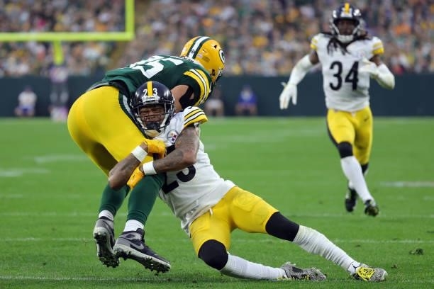 Robert Tonyan of the Green Bay Packers is tackled by Joe Haden of the Pittsburgh Steelers during the fourth quarter at Lambeau Field on October 03,...