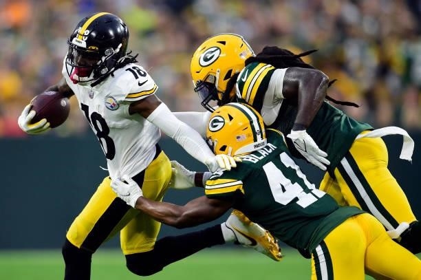 Diontae Johnson of the Pittsburgh Steelers is tackled by Henry Black of the Green Bay Packers during the second half at Lambeau Field on October 03,...
