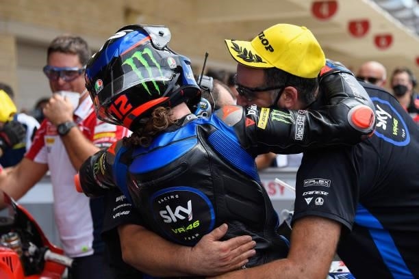 Marco Bezzecchi of Italy and Sky Racing Team VR46 celebrates the third place with team under the podium during the Moto2 race during the MotoGP Of...