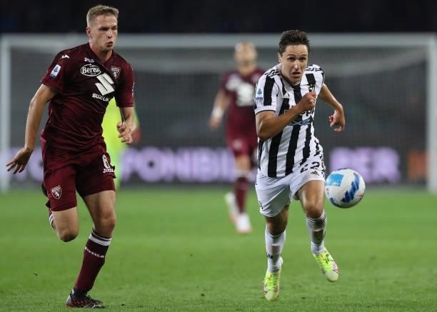 David Zima of Torino FC and Federico Chiesa of Juventus race after the ball during the Serie A match between Torino FC v Juventus at Stadio Olimpico...