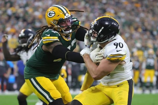 Billy Turner of the Green Bay Packers works against T.J. Watt of the Pittsburgh Steelers during a game at Lambeau Field on October 03, 2021 in Green...