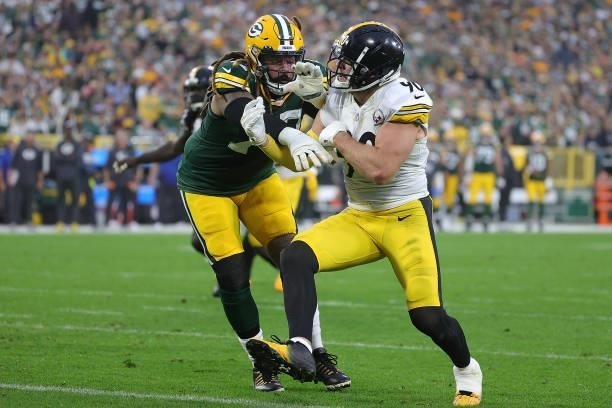 Billy Turner of the Green Bay Packers works against T.J. Watt of the Pittsburgh Steelers during a game at Lambeau Field on October 03, 2021 in Green...