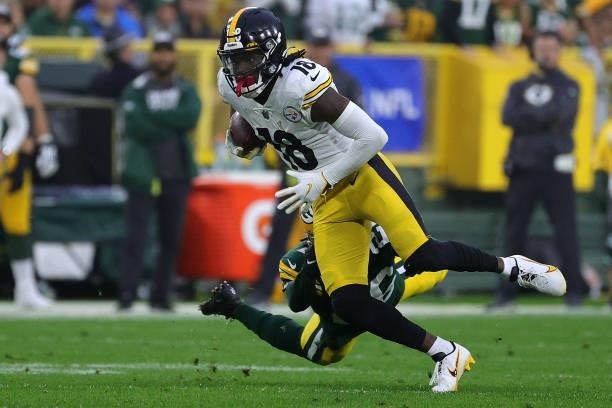 Diontae Johnson of the Pittsburgh Steelers avoids a tackle by Darnell Savage of the Green Bay Packers during a game at Lambeau Field on October 03,...