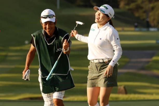 Minami Katsu of Japan celebrates with her caddie after winning the tournament on the 18th green during the final round of the 54th Japan Women's Open...