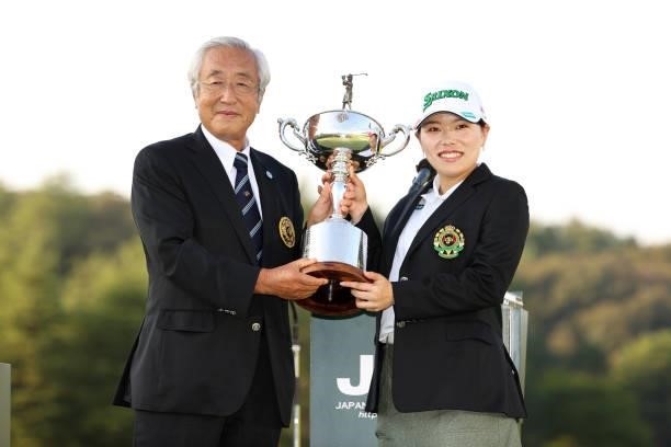 Minami Katsu of Japan is presented the trophy by Japan Golf Association CEO Tsunetada Takeda at the award ceremony after winning the tournament...