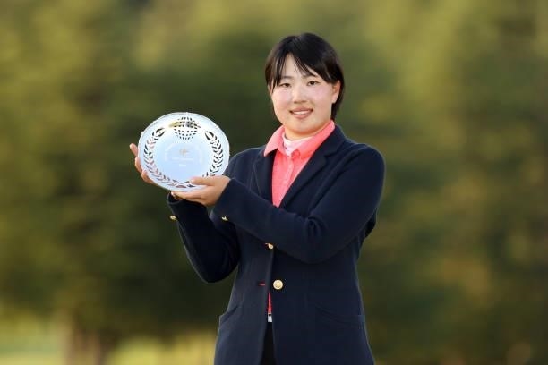 Low amateur Rio Takeda poses for photographs after the award ceremony following the final round of the 54th Japan Women's Open Golf Championship at...