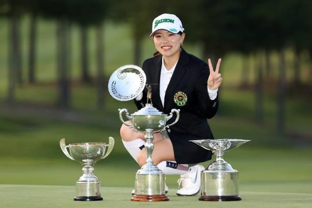 Minami Katsu of Japan poses with the trophies after winning the tournament following the final round of the 54th Japan Women's Open Golf Championship...