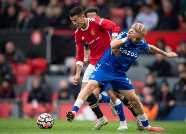 Cristiano Ronaldo of Manchester United battles with Tom Davies of Everton during the Premier League match between Manchester United and Everton at...