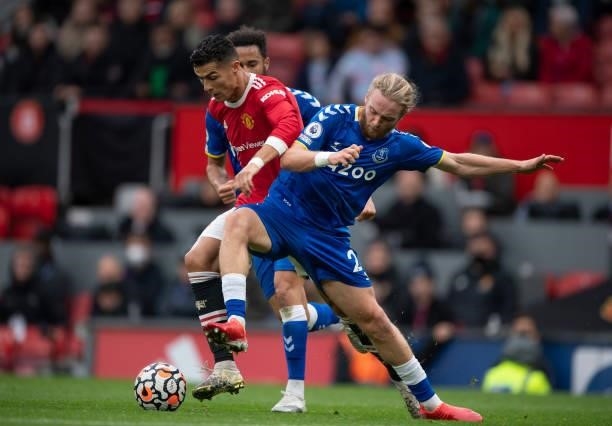Cristiano Ronaldo of Manchester United battles with Tom Davies of Everton during the Premier League match between Manchester United and Everton at...