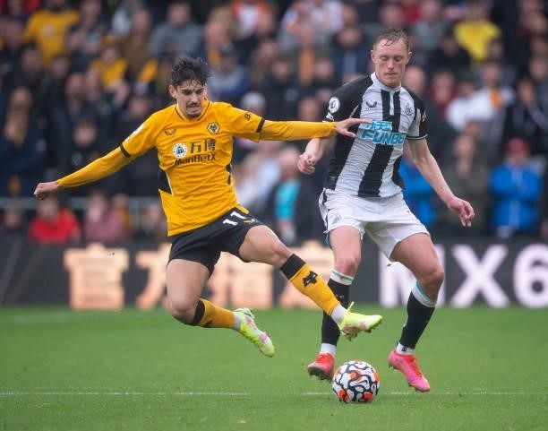 Sean Longstaff of Newcastle United and Francisco Trincao of Wolverhampton Wanderers in action during the Premier League match between Wolverhampton...